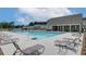 Community pool with lounge chairs and clubhouse offers a relaxing outdoor space for residents at 2700 Westgate Park Dr, Loganville, GA 30052