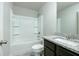 Bathroom featuring a tub and shower combo, granite countertop, and dark wood cabinets at 3018 Old Covington Rd, Covington, GA 30014