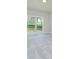 Bedroom features gray carpet and walls with a large window offering an outdoor view at 3018 Old Covington Rd, Covington, GA 30014