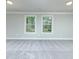 Large bedroom features neutral carpet, and windows to the backyard at 3018 Old Covington Rd, Covington, GA 30014