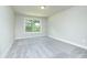 Bright bedroom with gray carpet, neutral walls, and large window for natural light at 3018 Old Covington Rd, Covington, GA 30014