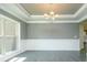 Dining area with gray walls, white trim, hardwood floors, and modern chandelier at 3018 Old Covington Rd, Covington, GA 30014