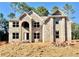 New two-story brick home featuring a symmetrical design, arched entry, and bright, spacious windows at 3018 Old Covington Rd, Covington, GA 30014