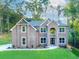 Elegant two-story brick home featuring a well-manicured lawn and beautiful landscaping at 3018 Old Covington Rd, Covington, GA 30014