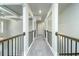 Upstairs hallway with carpet and iron railing at 3018 Old Covington Rd, Covington, GA 30014