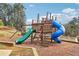 Community playground with slides and swings set against a backdrop of mature trees at 103 Timber Ridge Dr, Cartersville, GA 30121
