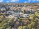 An aerial view of residences nestled amongst trees in a quiet neighborhood under a clear blue sky at 128 Graybrook Ct, Grayson, GA 30017