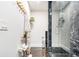 Modern bathroom featuring a glass shower with black marble style tiles at 128 Graybrook Ct, Grayson, GA 30017