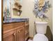 Bathroom vanity features granite counters, wood cabinets, and modern fixtures, complemented by unique decor at 128 Graybrook Ct, Grayson, GA 30017