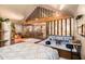 Open bedroom boasts wood floors, a sitting area, glass partitions, and a king bed with decorative bedding at 128 Graybrook Ct, Grayson, GA 30017