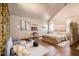 Bright bedroom features a fireplace, sitting area, and king bed with plush bedding, creating a cozy retreat at 128 Graybrook Ct, Grayson, GA 30017
