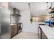Well-lit kitchen features stainless steel appliances and white tiled backsplash at 128 Graybrook Ct, Grayson, GA 30017