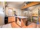 Kitchenette area featuring granite counters, stainless appliances, and adjacent access to upper level at 128 Graybrook Ct, Grayson, GA 30017