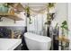 Modern bathroom featuring a soaking tub, black marble tile, and decorative shelving at 128 Graybrook Ct, Grayson, GA 30017