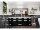 Bathroom featuring dual sinks, black marble tile, lots of storage space, and decorative shelving at 128 Graybrook Ct, Grayson, GA 30017