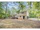 Backyard of home featuring a deck and a wooded area at the property line at 155 S South Meadowcliff Cir, Carrollton, GA 30116