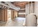 Unfinished basement featuring exposed ducts, concrete floors, and access to another part of the home at 155 S South Meadowcliff Cir, Carrollton, GA 30116