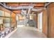 Unfinished basement with concrete floor, exposed ducts, shelving, and stairs to main floor at 155 S South Meadowcliff Cir, Carrollton, GA 30116