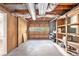 View of unfinished basement with concrete floor and exposed ducts, with open shelving at 155 S South Meadowcliff Cir, Carrollton, GA 30116