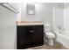 Bathroom featuring a vanity with a black cabinet and a standard bathtub with shower at 155 S South Meadowcliff Cir, Carrollton, GA 30116
