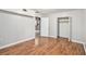 View of a bedroom featuring wood-look floors, neutral walls, a closet, and open doorway at 155 S South Meadowcliff Cir, Carrollton, GA 30116