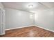 Bedroom featuring neutral walls, wood-look flooring, and a single window for natural light at 155 S South Meadowcliff Cir, Carrollton, GA 30116