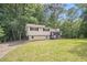 Charming two-story home with a well-maintained lawn and mature trees, providing a serene and inviting curb appeal at 155 S South Meadowcliff Cir, Carrollton, GA 30116