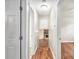 Hallway with hardwood floors and doorways to the living room and bedrooms at 155 S South Meadowcliff Cir, Carrollton, GA 30116