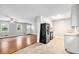 View from the Living Room into the Kitchen with stainless steel appliances, bright cabinets, and great natural light at 155 S South Meadowcliff Cir, Carrollton, GA 30116