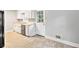 The kitchen boasts bright cabinets, stainless steel appliances, and plenty of natural light and adjoins the living room at 155 S South Meadowcliff Cir, Carrollton, GA 30116