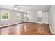 Inviting living room featuring beautiful hardwood floors, a ceiling fan, and abundant natural light from multiple windows at 155 S South Meadowcliff Cir, Carrollton, GA 30116