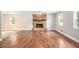 Spacious living room featuring hardwood floors, a stone fireplace, a ceiling fan, and lots of natural light at 155 S South Meadowcliff Cir, Carrollton, GA 30116