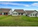 Exterior view of backyard featuring well maintained lawn, house, and neighboring properties at 178 Sunshower Rdg, Canton, GA 30114