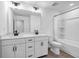 Bright bathroom featuring a double vanity, modern fixtures, and a shower-tub combo with tile surround at 178 Sunshower Rdg, Canton, GA 30114
