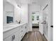 Bright bathroom featuring double vanity, sleek fixtures, wood-look tile floor, and access to bedroom with fan at 178 Sunshower Rdg, Canton, GA 30114
