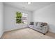 Inviting room featuring neutral carpet, a comfortable sofa, and a bright window at 178 Sunshower Rdg, Canton, GA 30114