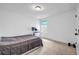 This cozy bedroom offers neutral carpet, a window view, and space for a desk and workout equipment at 178 Sunshower Rdg, Canton, GA 30114