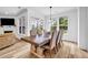 Bright dining room with a decorative chandelier, seating for eight, and views of the backyard at 178 Sunshower Rdg, Canton, GA 30114