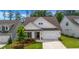 Charming home with white siding, a well-manicured lawn, and a two-car garage at 178 Sunshower Rdg, Canton, GA 30114