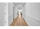 Bright hallway with wood floors, white trim, and an open view into other rooms at 178 Sunshower Rdg, Canton, GA 30114