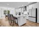 Elegant kitchen featuring a large island with seating, modern appliances, and a dining area at 178 Sunshower Rdg, Canton, GA 30114