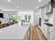 Open kitchen featuring white cabinets, stainless steel appliances, and a large island with quartz countertops at 178 Sunshower Rdg, Canton, GA 30114