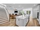 Open-concept living space featuring a large island, stairs, and views of the living room at 178 Sunshower Rdg, Canton, GA 30114
