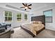 Spacious main bedroom with tray ceilings, a king bed, and lots of natural light from three windows at 178 Sunshower Rdg, Canton, GA 30114