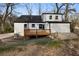 Backyard view featuring a wooden deck, stone patio, and modern architectural details at 1870 Avon Sw Ave, Atlanta, GA 30311