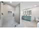 Bright bathroom featuring a glass shower, modern tile, and a stylish vanity with dual sinks at 1870 Avon Sw Ave, Atlanta, GA 30311