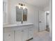 Updated bathroom featuring a modern vanity with a large mirror and elegant lighting at 1870 Avon Sw Ave, Atlanta, GA 30311