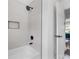 Close-up of shower/bath combo featuring modern fixtures and white tile at 1870 Avon Sw Ave, Atlanta, GA 30311