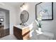 Bathroom features a stylish vanity, modern fixtures, and a floral arrangement at 1870 Avon Sw Ave, Atlanta, GA 30311