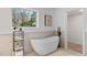 Modern bathroom showcasing a standalone tub, sleek fixtures, and a bright window view at 1870 Avon Sw Ave, Atlanta, GA 30311